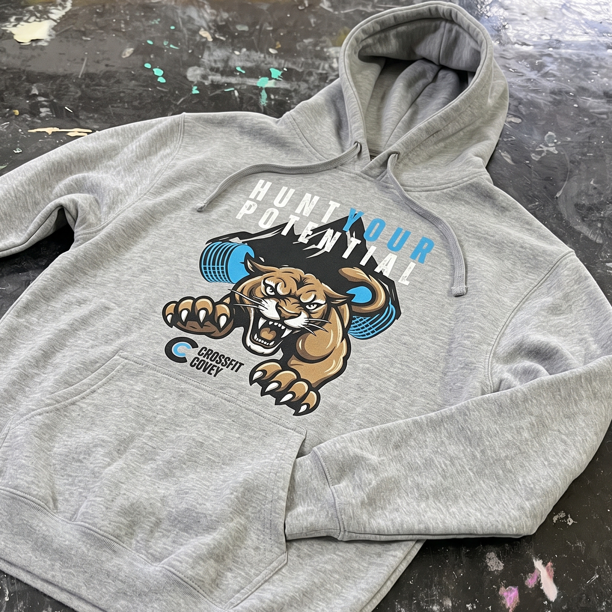 Heather gray hoodie with roaring cougar and blue barbell graphic