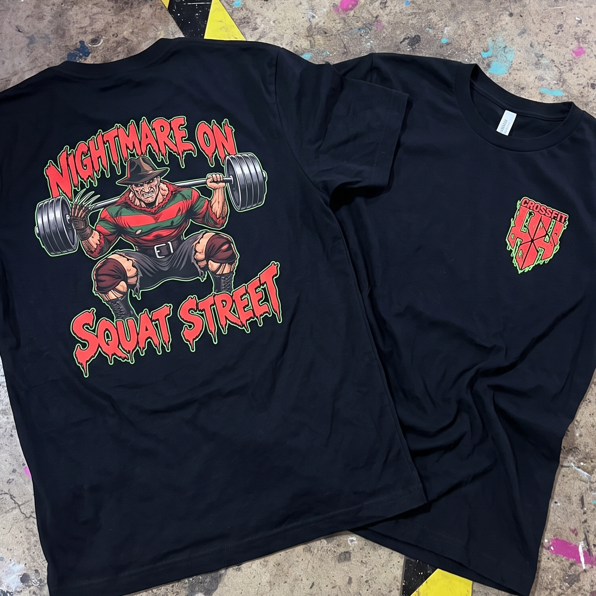 Black tees showing a dripping Nightmare on Squat Street graphic and small CrossFit Hoka Hey chest print.