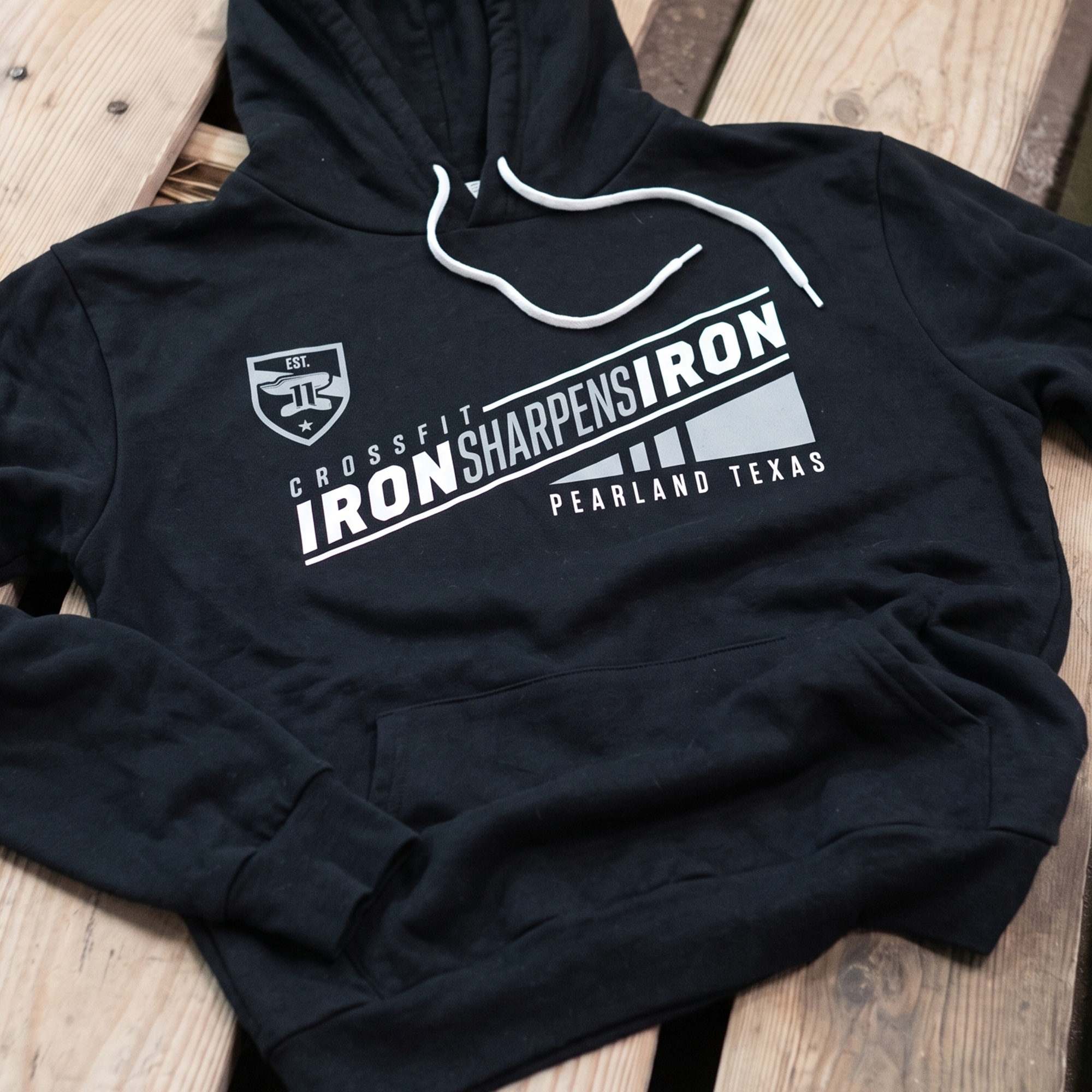 Black hoodie with silver-gray diagonal CrossFit Iron Sharpens Iron graphic