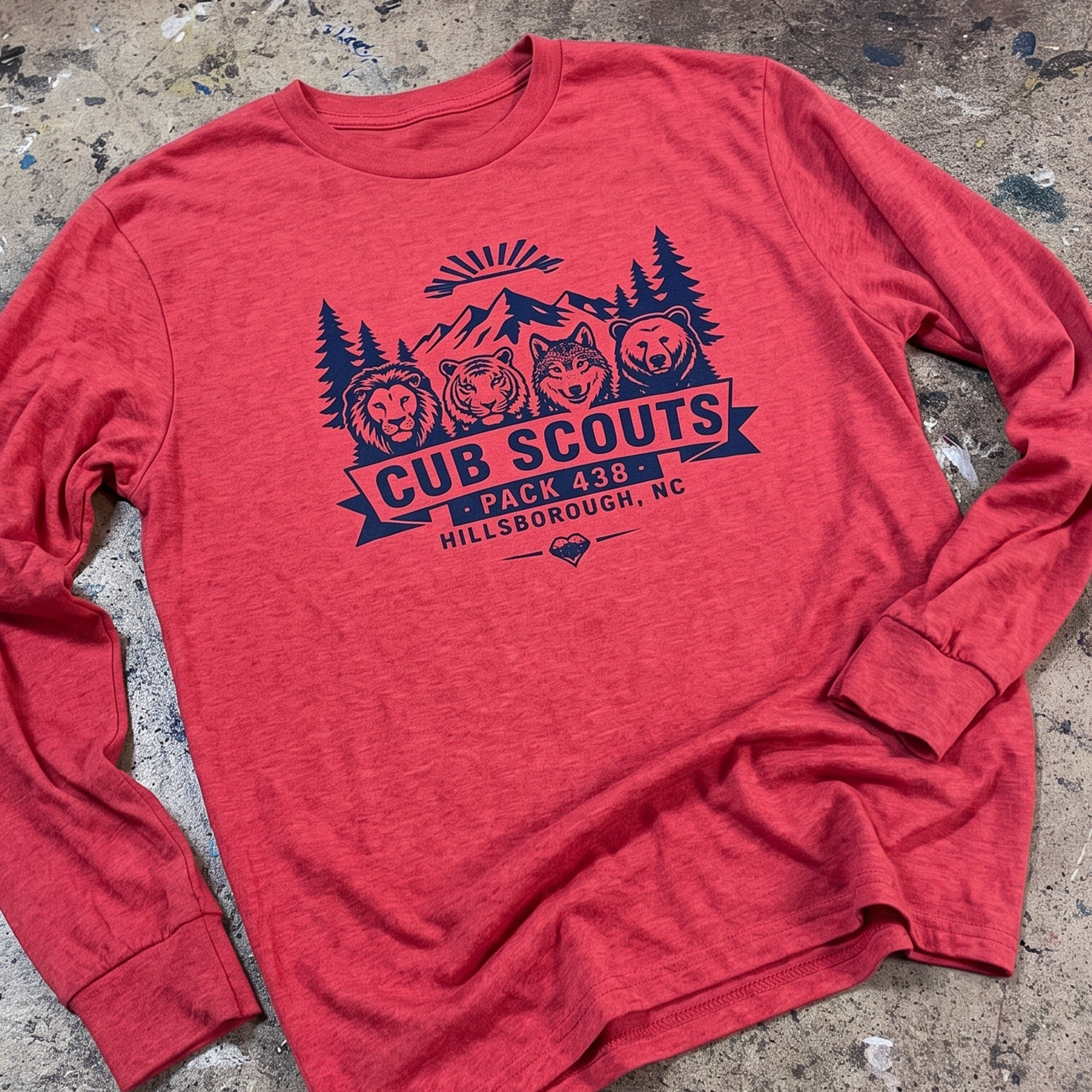 Red long-sleeve shirt with navy Cub Scouts Pack 438 mountain and animal graphic.