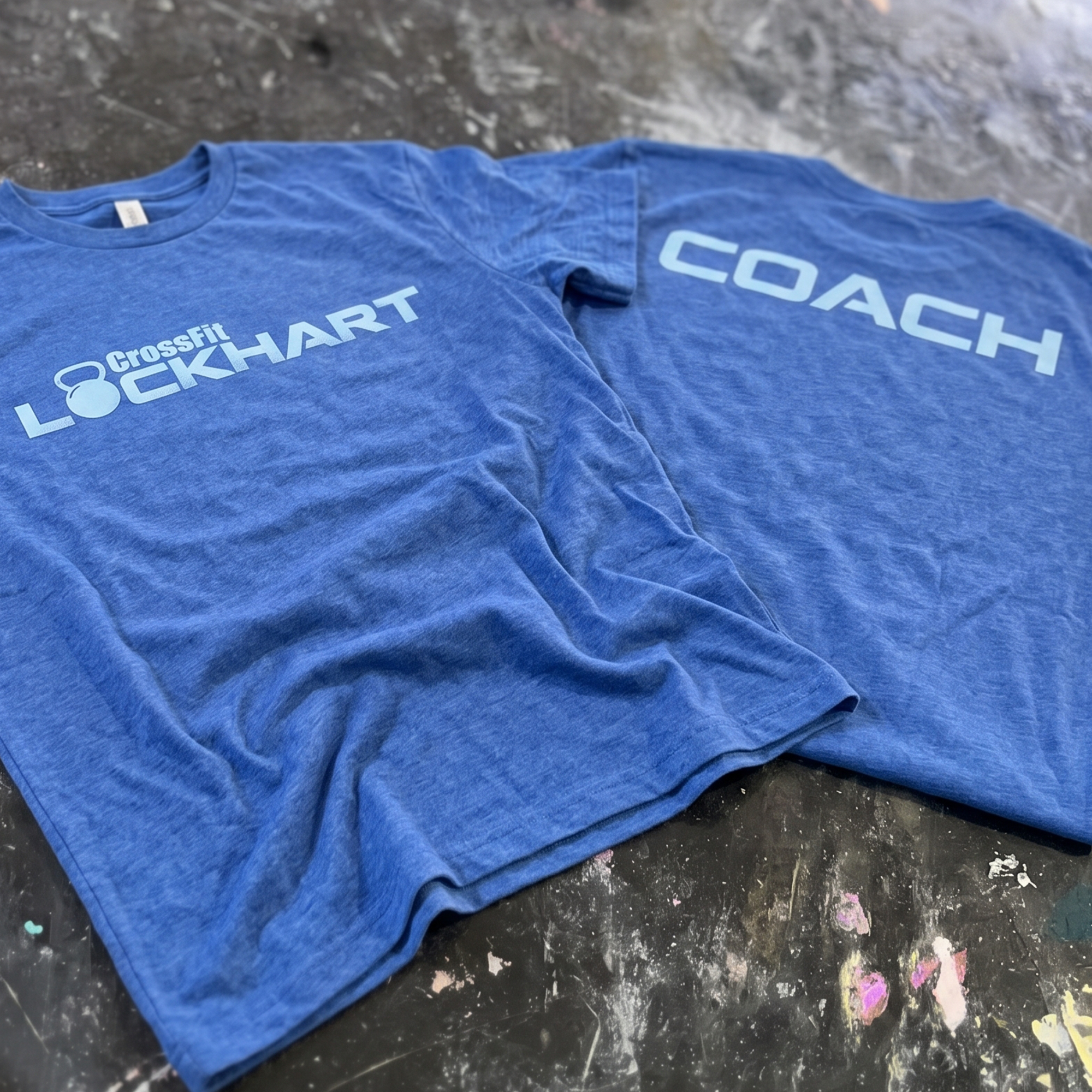 Royal blue tees with light blue CrossFit Lockhart and COACH prints.