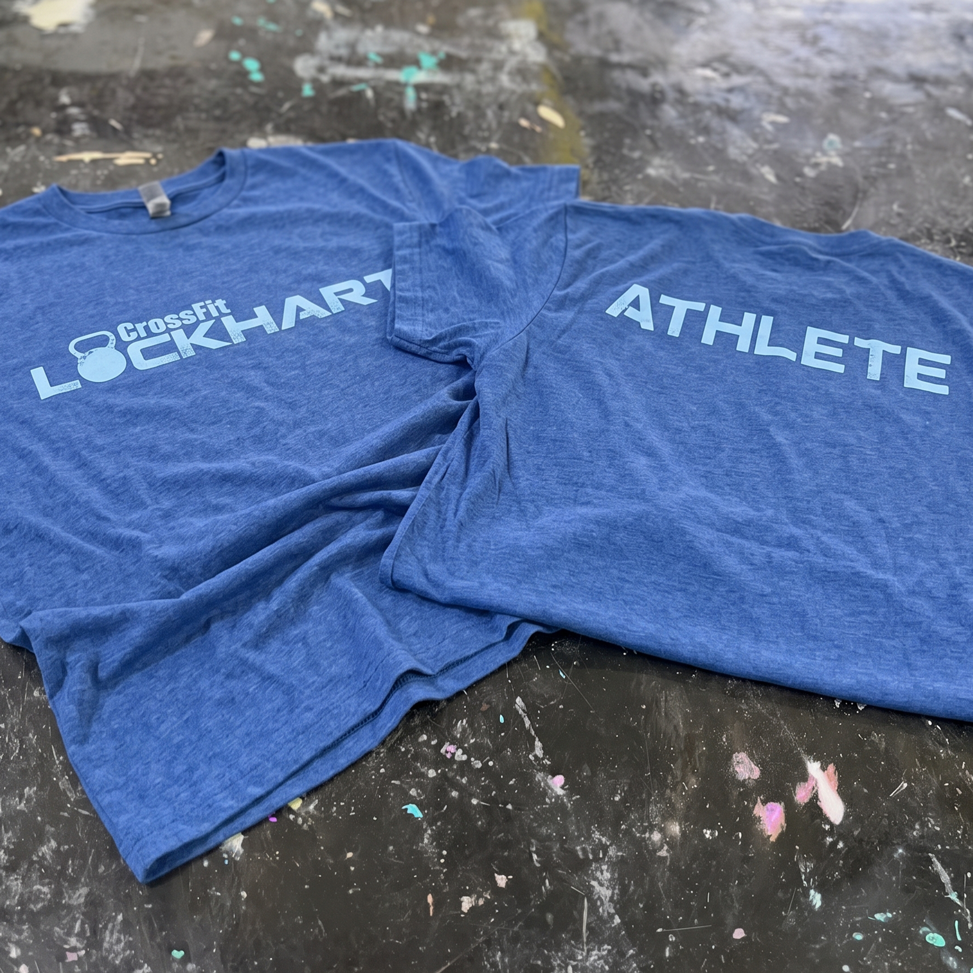 Royal blue shirts showing CrossFit Lockhart and ATHLETE light blue prints.