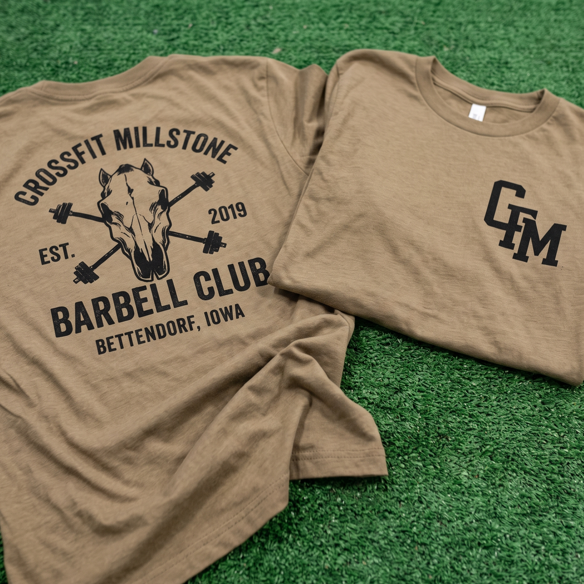 Tan tee with horse skull barbell club back print and CFM chest monogram.