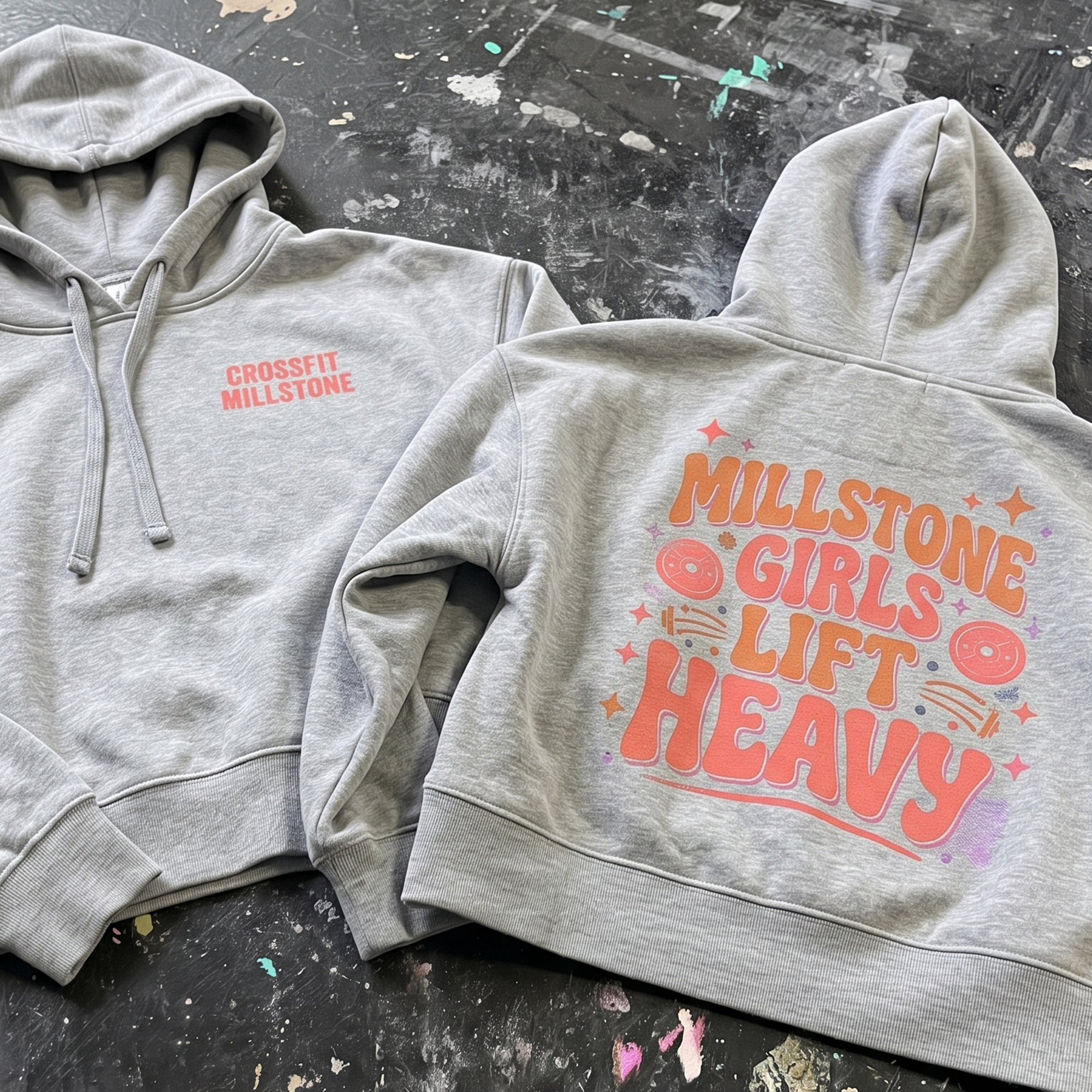 Gray hoodie with small CrossFit Millstone chest print and colorful Millstone Girls Lift Heavy back graphic.