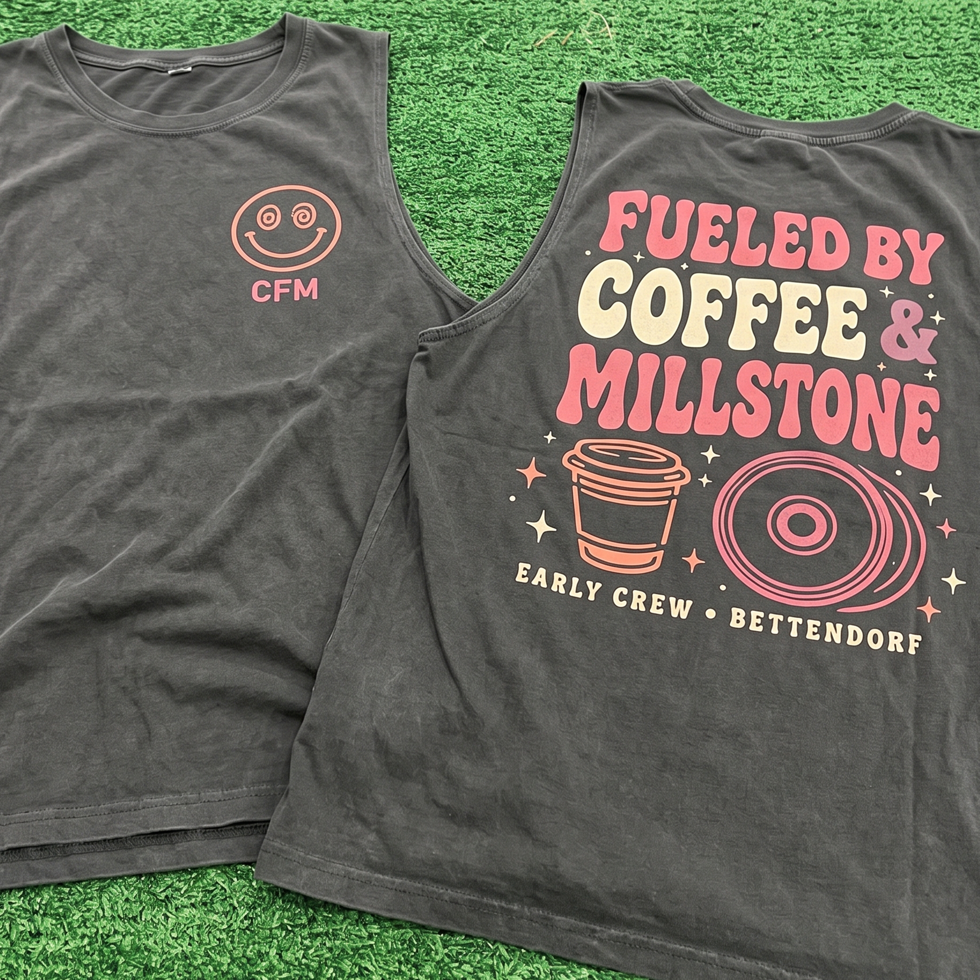Black tank with pink coffee-themed back print and smiley CFM chest mark.