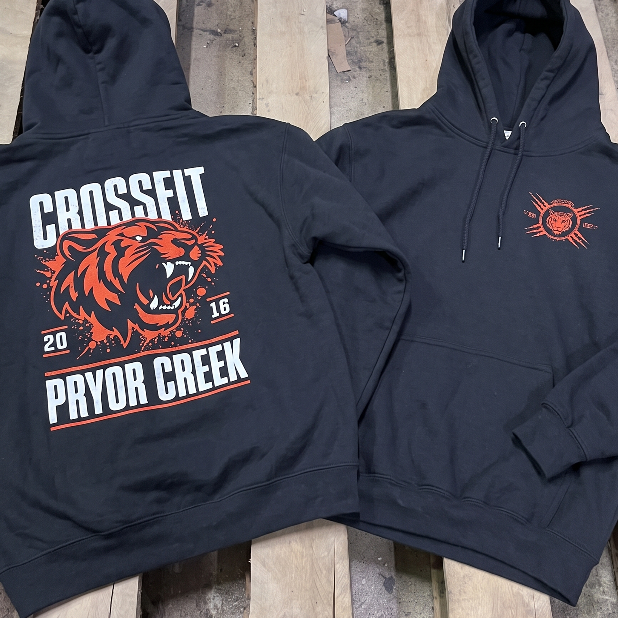 Black hoodie with coral tiger front and back prints.