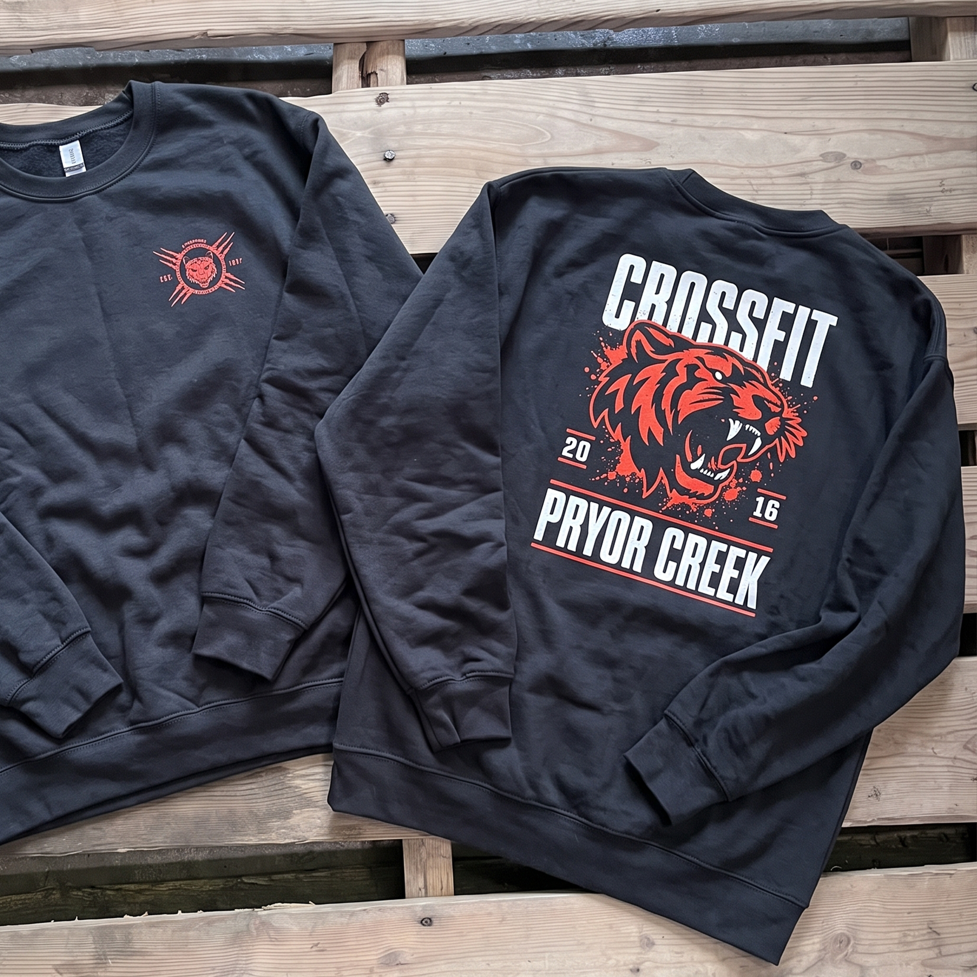 Black crewnecks with coral tiger chest and back prints.