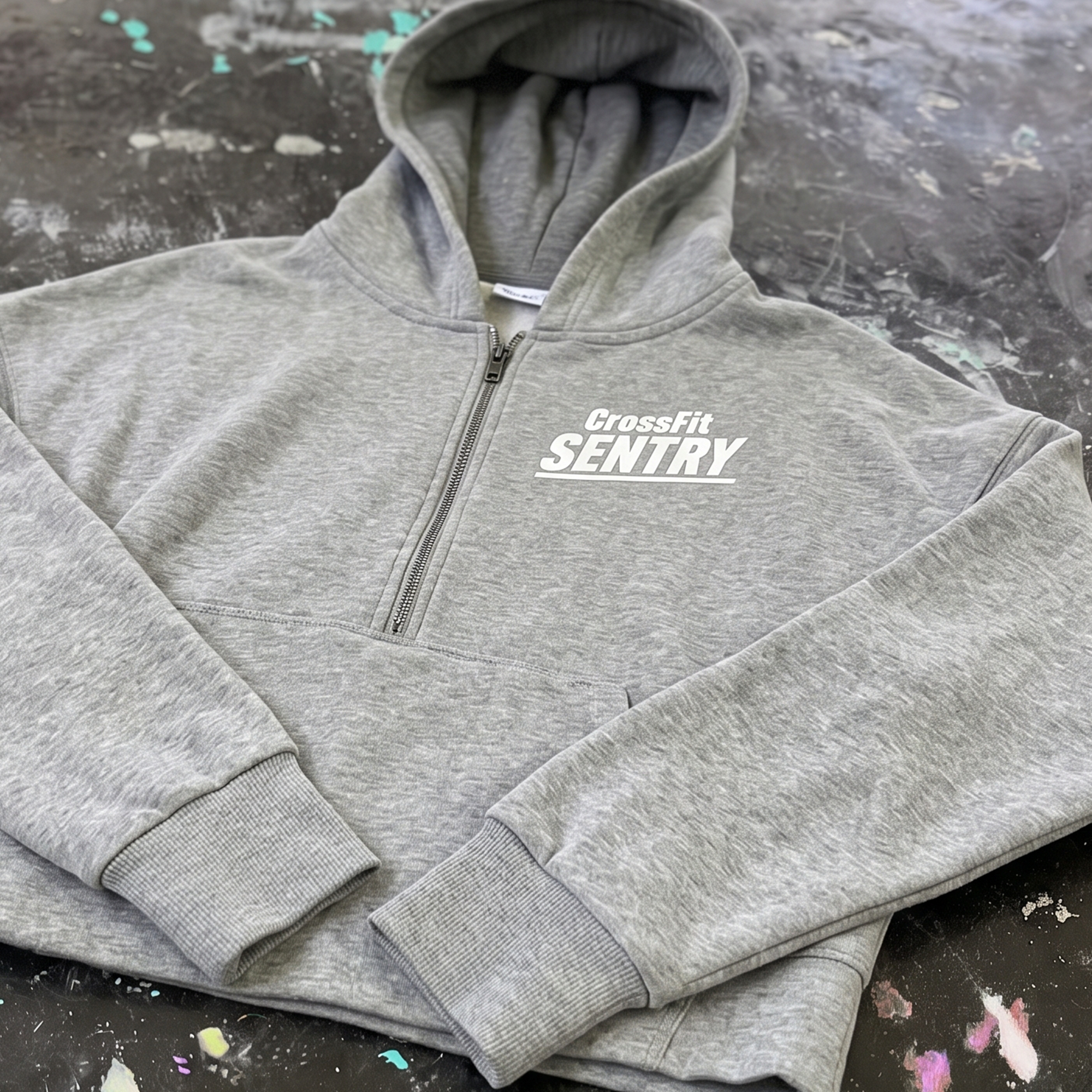 Heather gray quarter-zip hoodie with white left-chest CrossFit Sentry print.