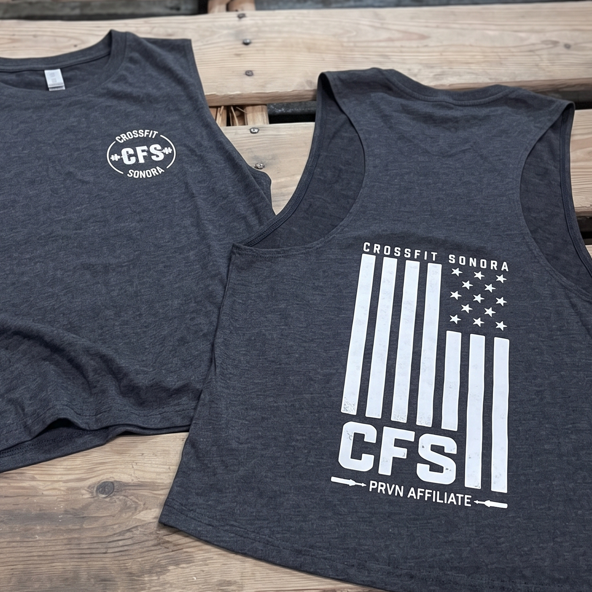 Dark heather tanks with white chest logo and flag-inspired CFS graphic.