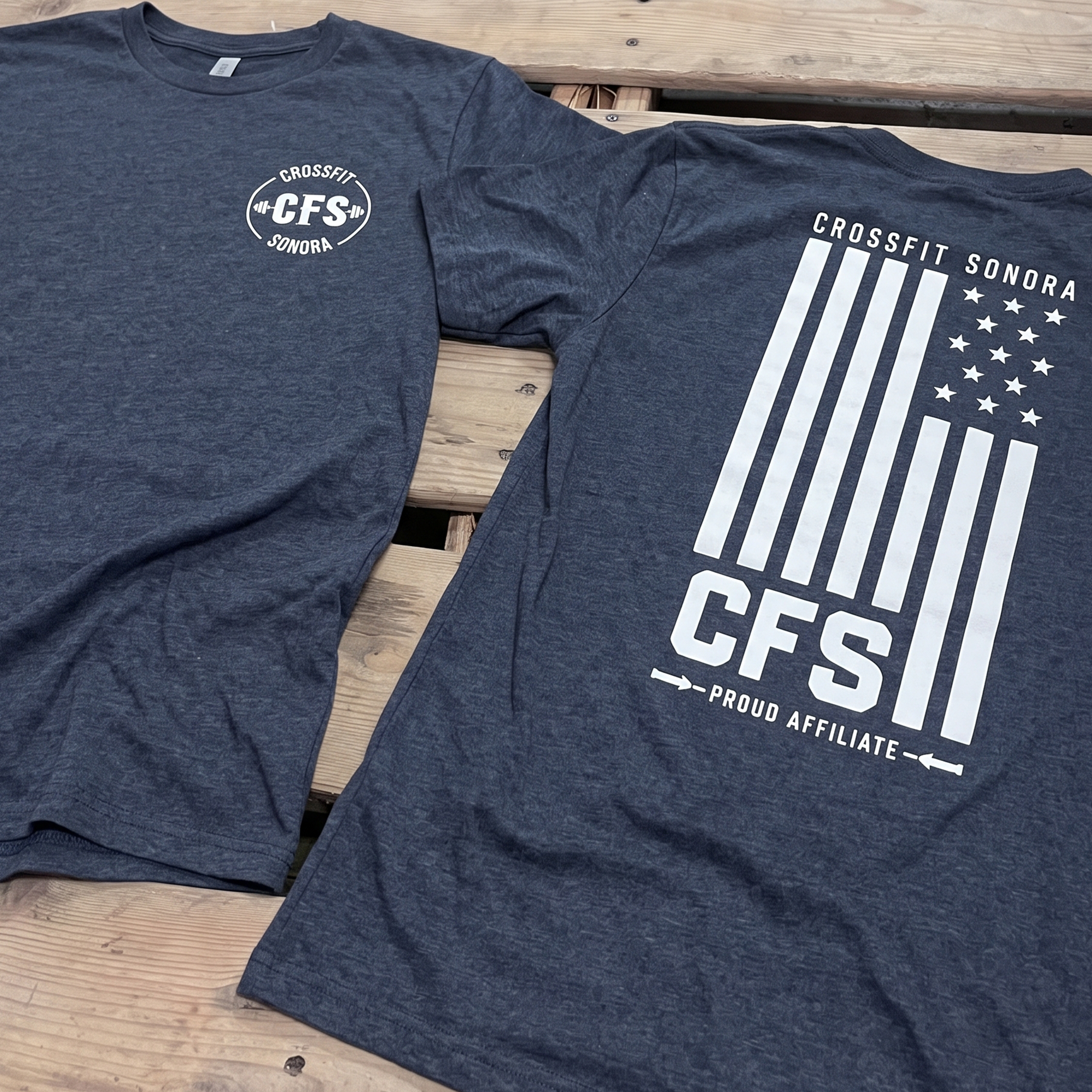Navy heather tees with white chest logo and flag-inspired CFS back print.