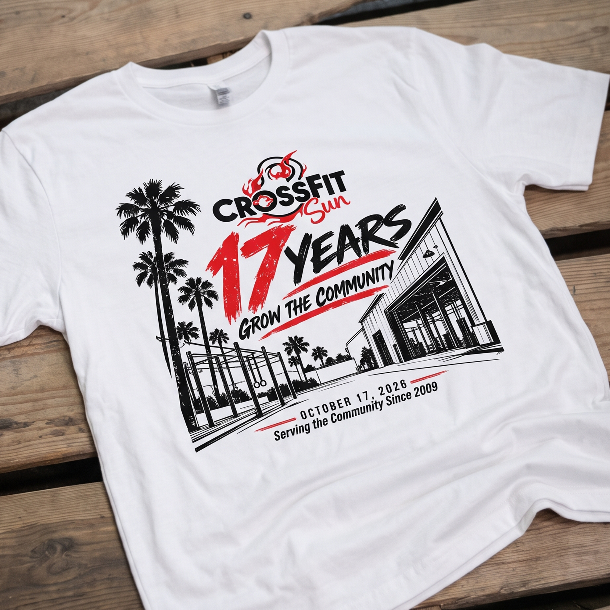 White CrossFit Sun event T-shirt with red and black 17 Years graphic, palm trees, outdoor rig and gym illustration.