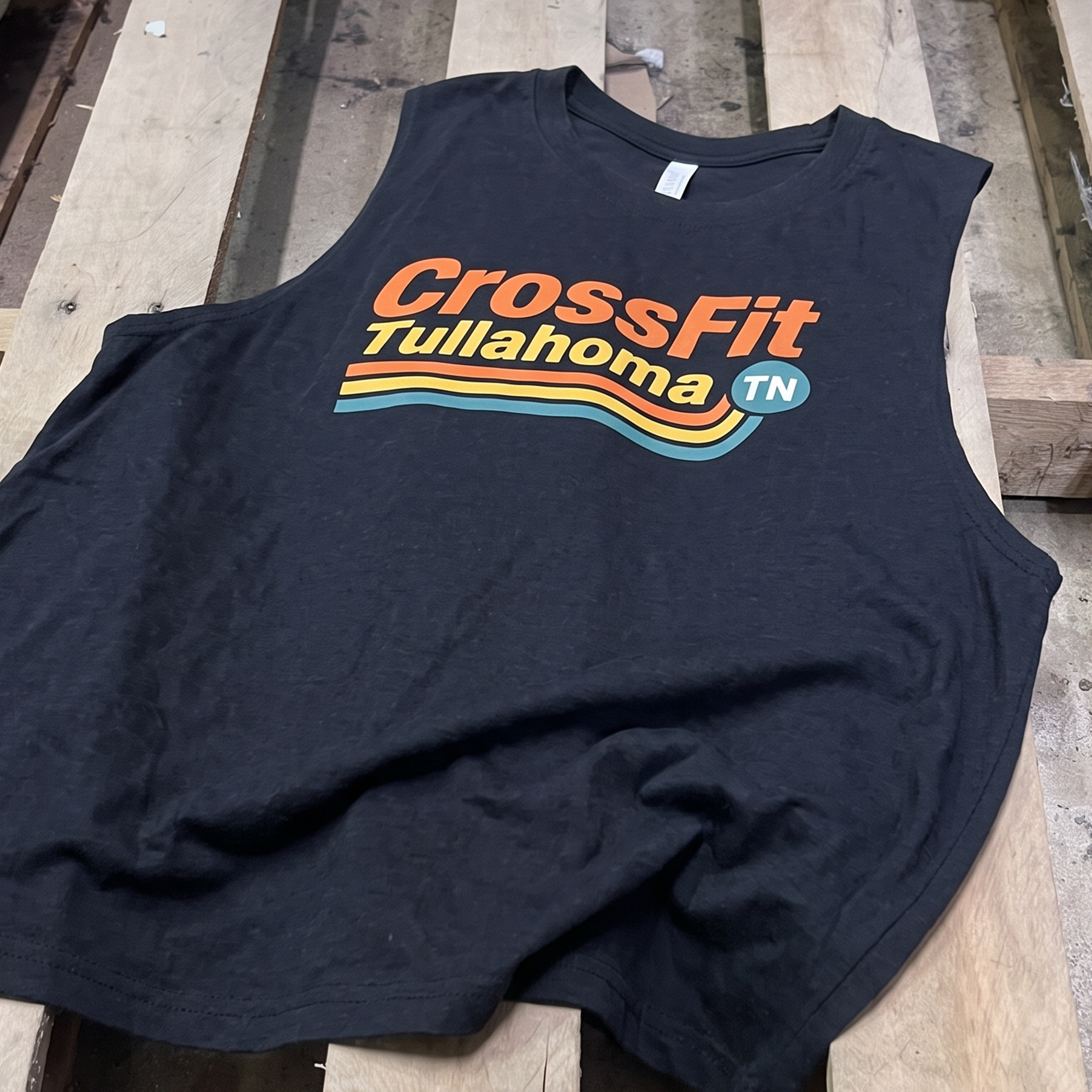 Black tank with orange, yellow and teal CrossFit Tullahoma stripe graphic.