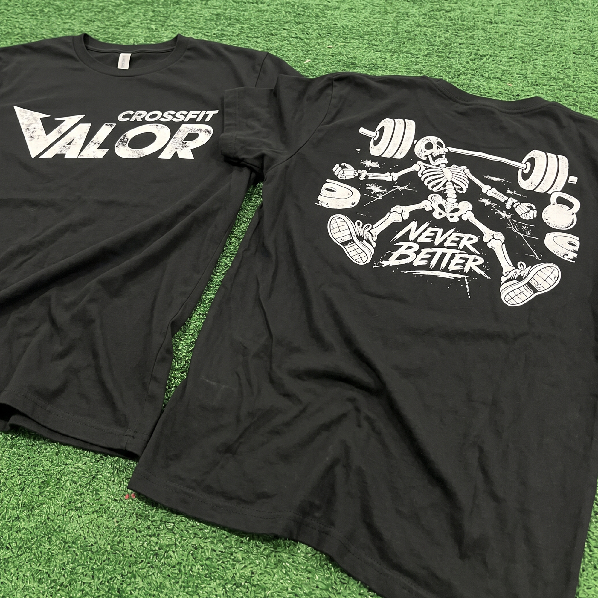 Close view of black tees with CrossFit Valor front print and skeleton back graphic.