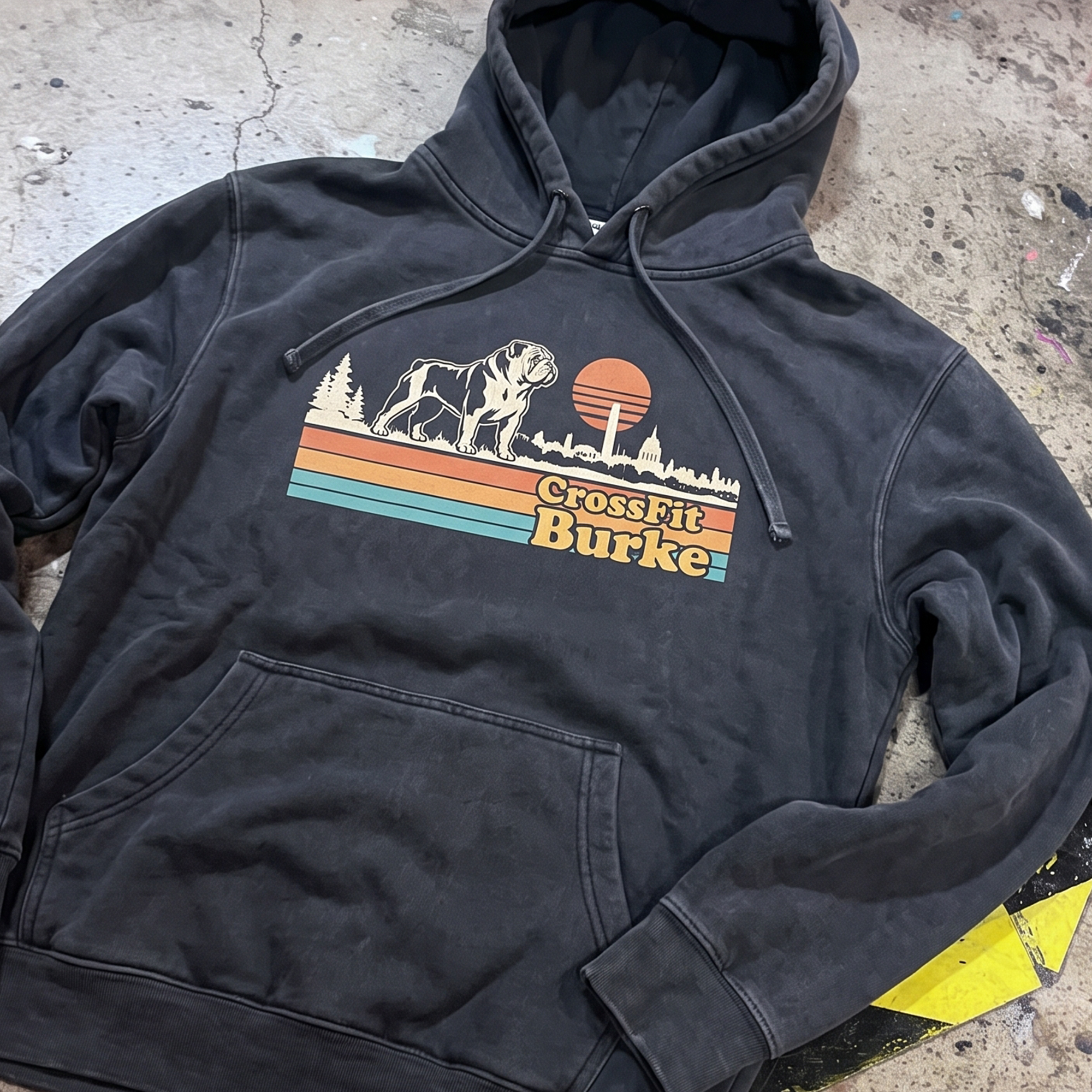 Black hoodie with retro CrossFit Burke bulldog and skyline graphic.
