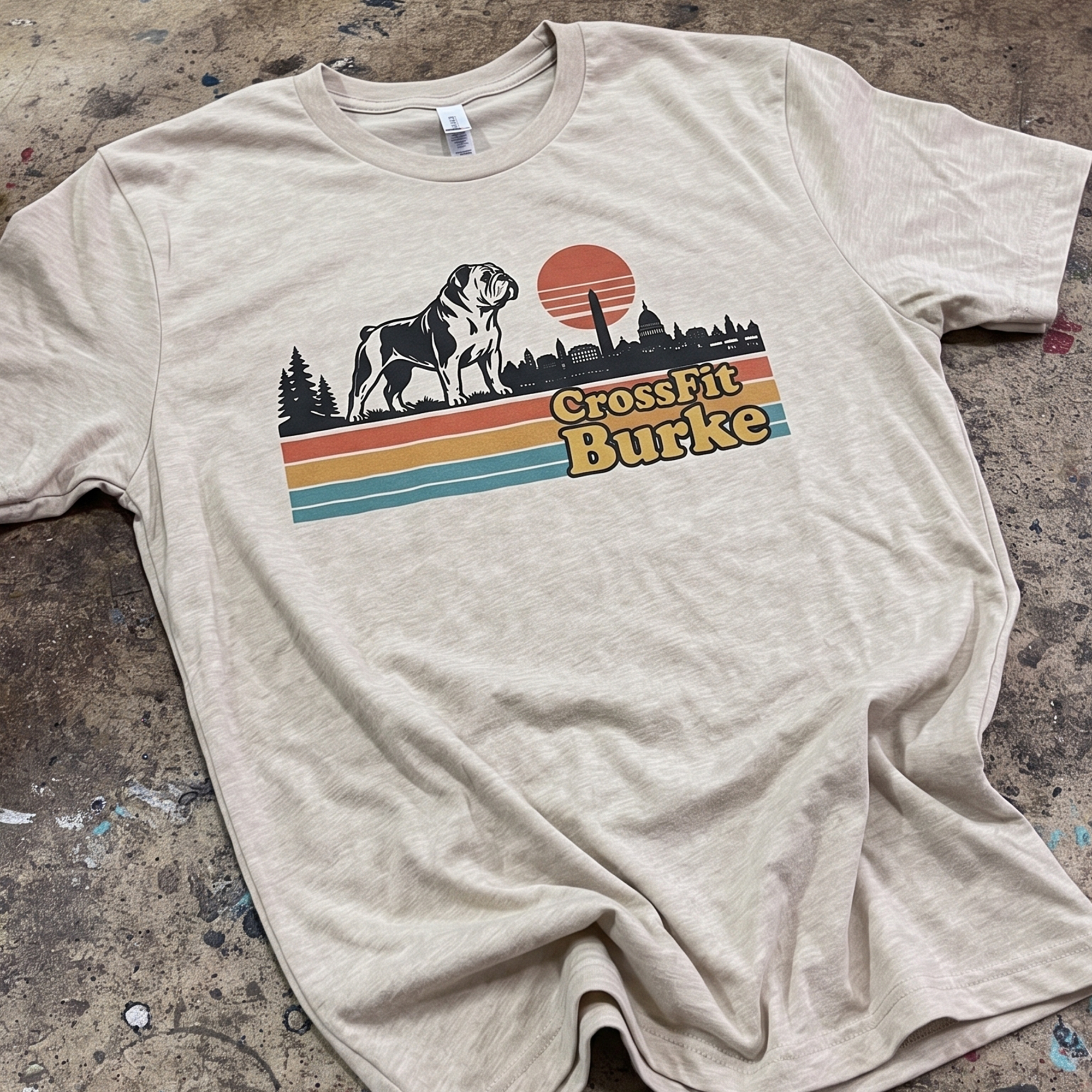 Cream T-shirt with retro CrossFit Burke bulldog and skyline graphic.
