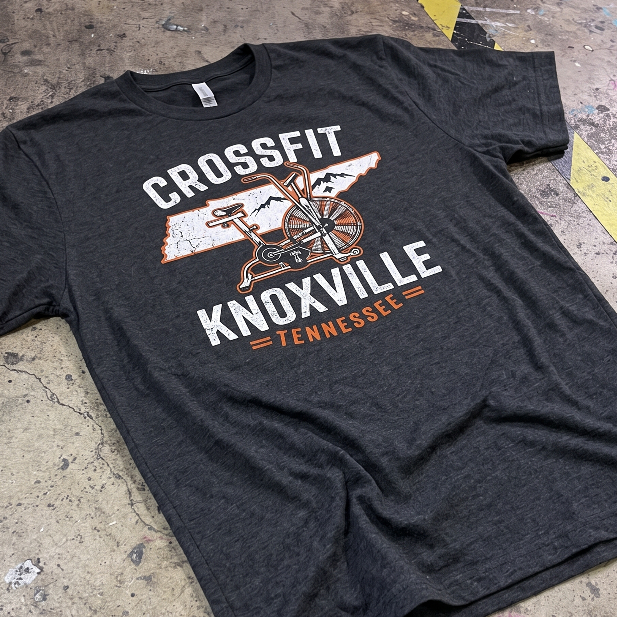 Black T-shirt with distressed CrossFit Knoxville air-bike and Tennessee graphic.