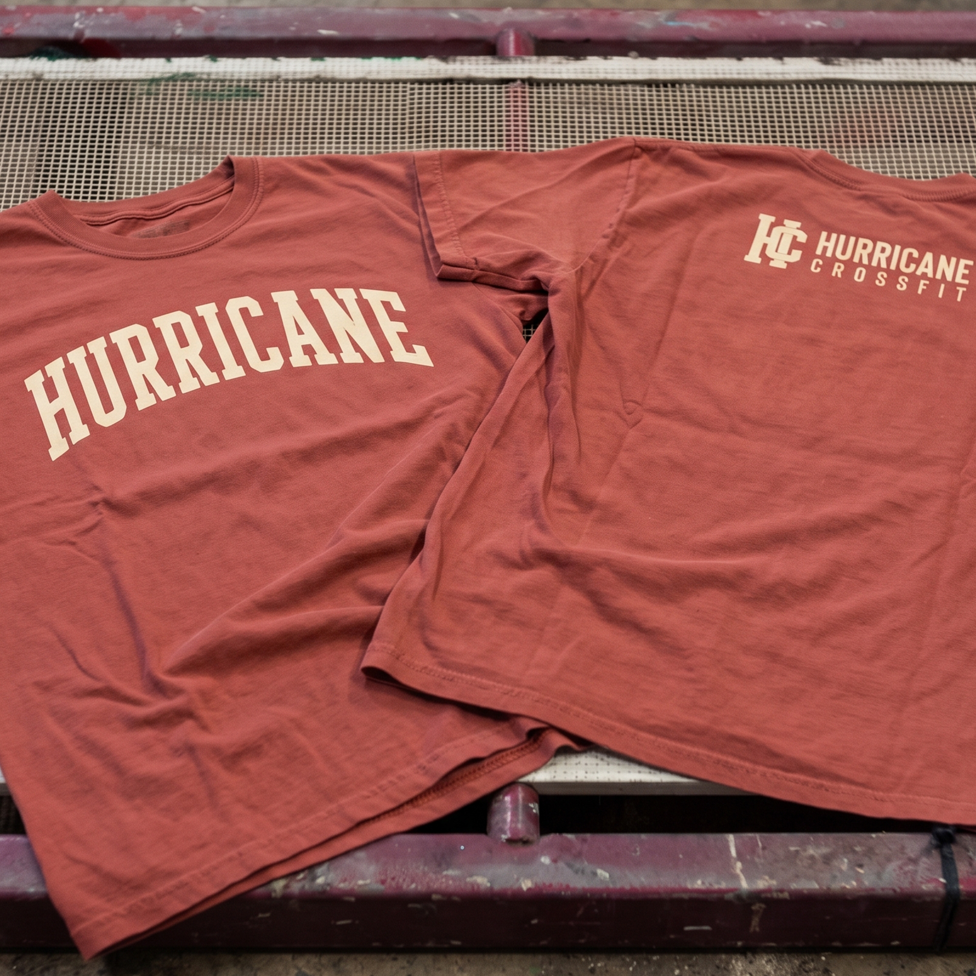 Brick red tees with cream Hurricane and Hurricane CrossFit prints.