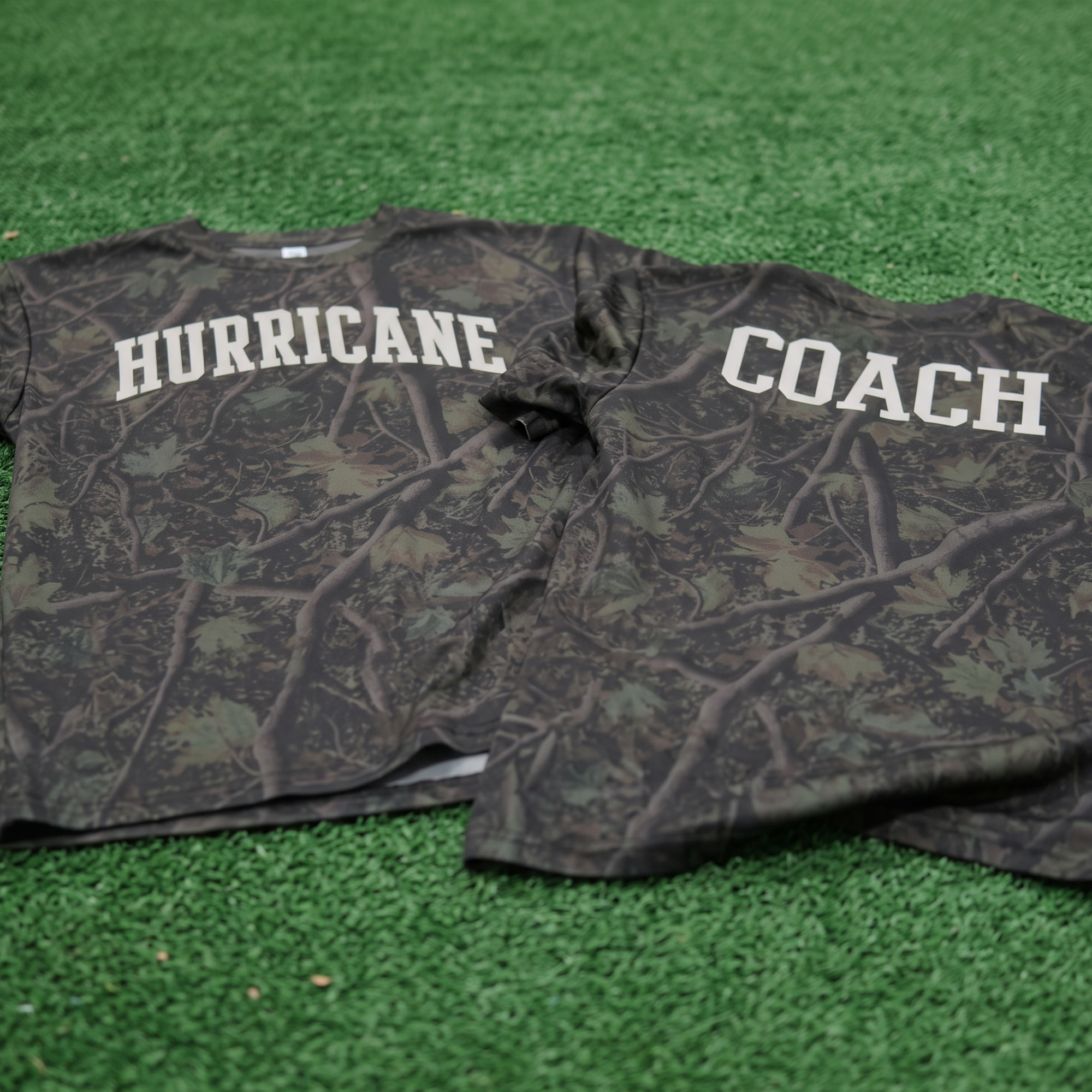 Camo long-sleeve shirts with cream Hurricane and Coach lettering.