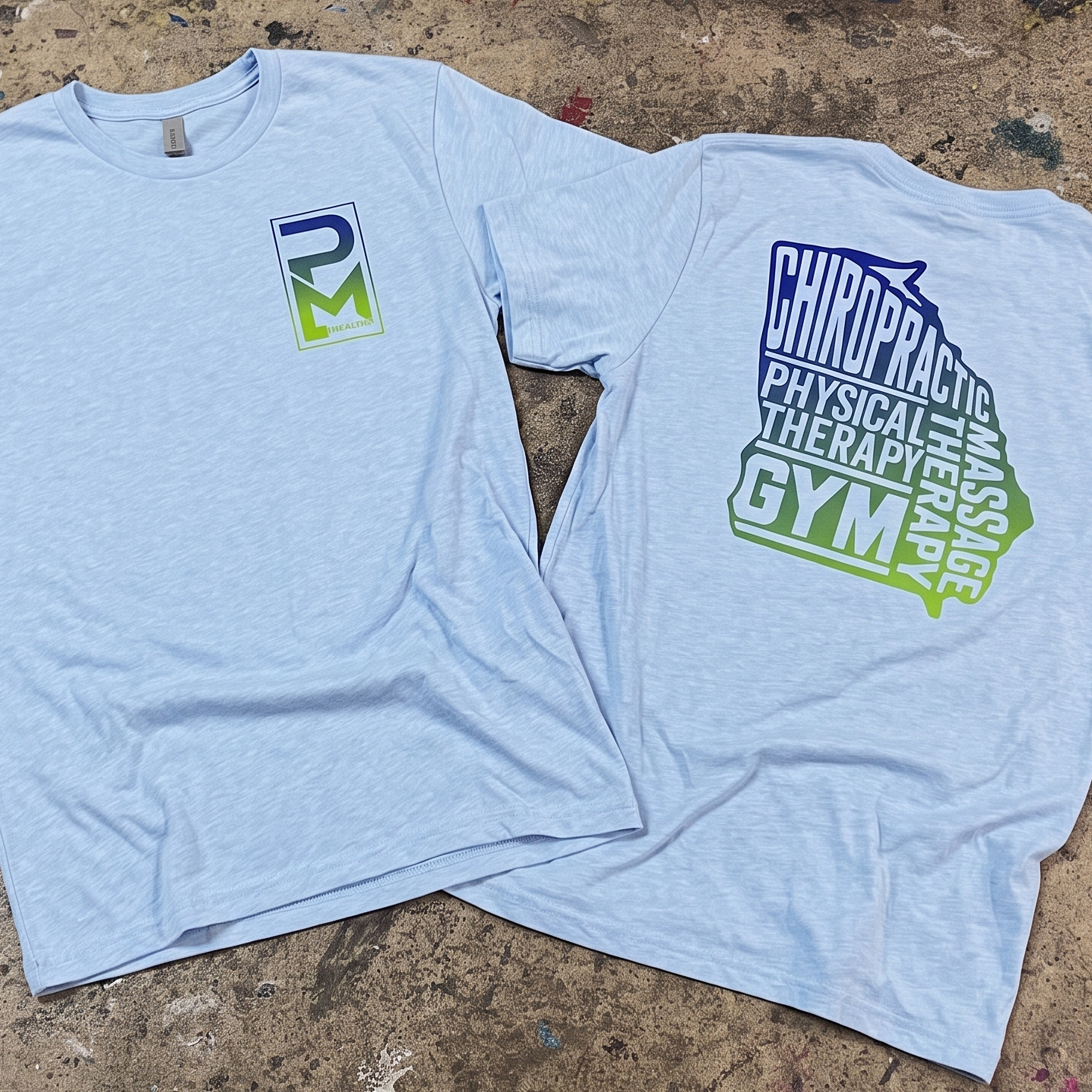 Light blue T-shirts with gradient PM Health chest logos and large stacked back graphics.